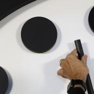 Hand moving the Doomsday Clock; Photo by Carolyn Kaster/Associated Press