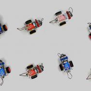 Non-reciprocal phase transitions - demonstration with tiny desktop robots
