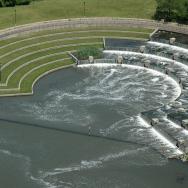 aerial view of a large stepped pool feeding into a river