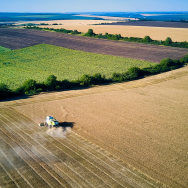A farming machine gathers crops on a wheat field