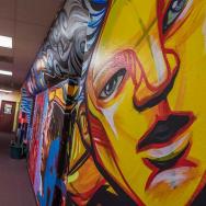 A mural-covered hallway at an IDJJ youth center in East Garfield Park, Chicago.