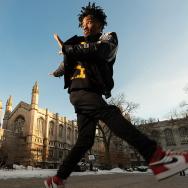Clinical researcher Derrick Judkins, also known as dancer Kid Nimbus, jumps into the air on the UChicago campus