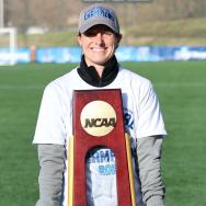 UChicago soccer coach Julianne Sitch with NCAA title trophy