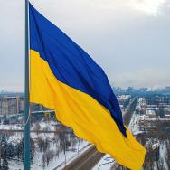 Ukraine flag with city in the background