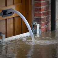 Photo of water being pumped out of a building door