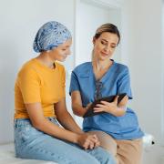 Teenage oncology patient talking with doctor.