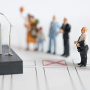 A display of miniature figures depicting a politician speaking to a group of people