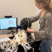 University of Chicago fourth-year student Bella Summe collects neural data using fNIRS at a UChicago Psychology Department lab.