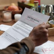 A person reads an eviction notice