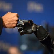 Robotic arm fist-bumping human arm