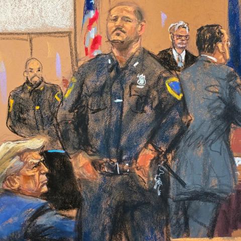 A courtroom drawing of Donald Trump, seen from the back, flanked by a police officer before the judge